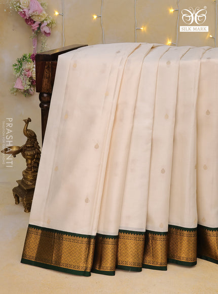 Pure kanchipuram silk saree off white and dark green with zari woven buttas and zari woven korvai border