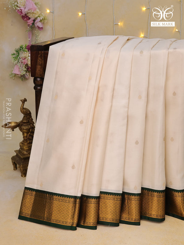 Pure kanchipuram silk saree off white and dark green with zari woven buttas and zari woven korvai border