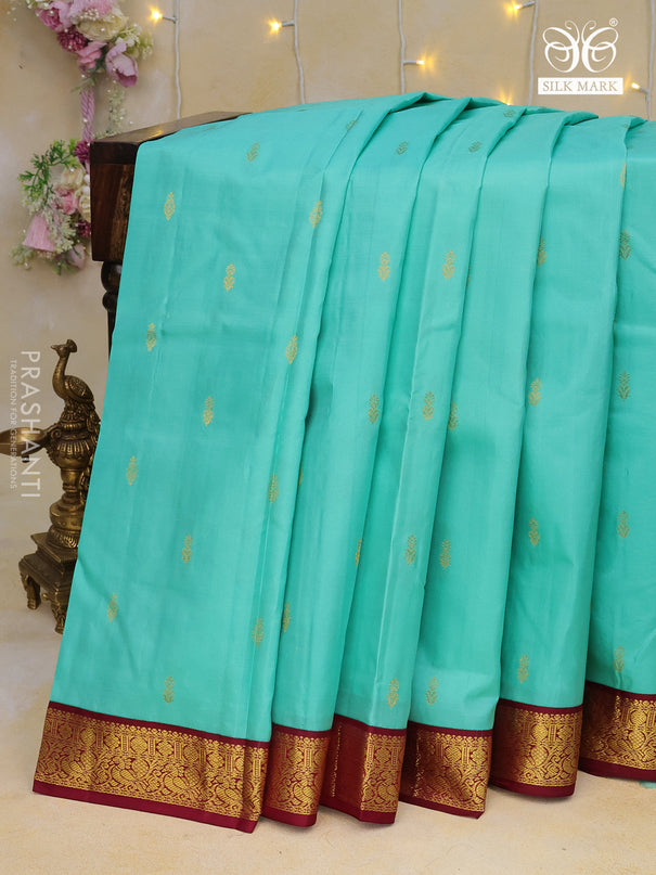 Pure kanchipuram silk saree teal blue and wine shade with zari woven buttas and zari woven korvai border