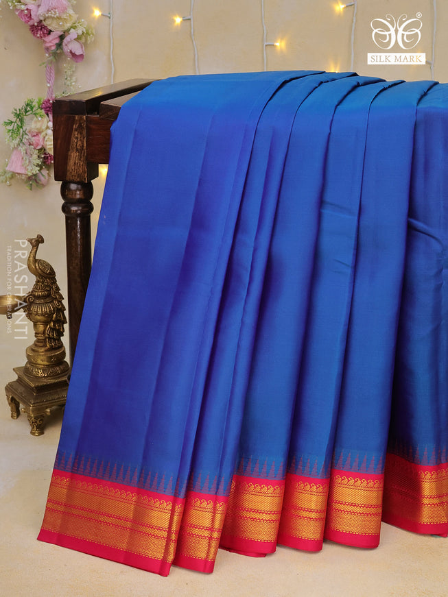 Pure kanchipuram silk saree dual shade of bluw and pink with plain body and temple design zari woven border