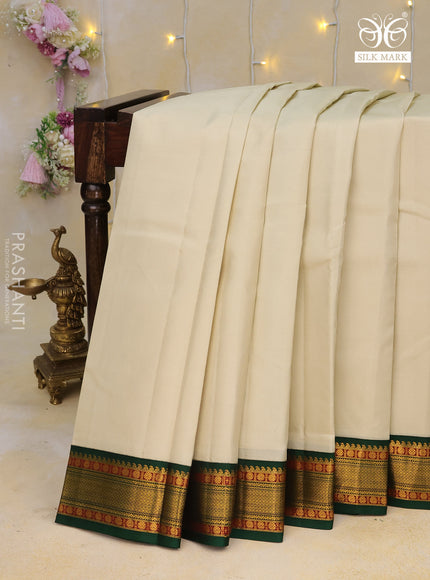 Pure kanchipuram silk saree cream and dark green with plain body and zari woven korvai border