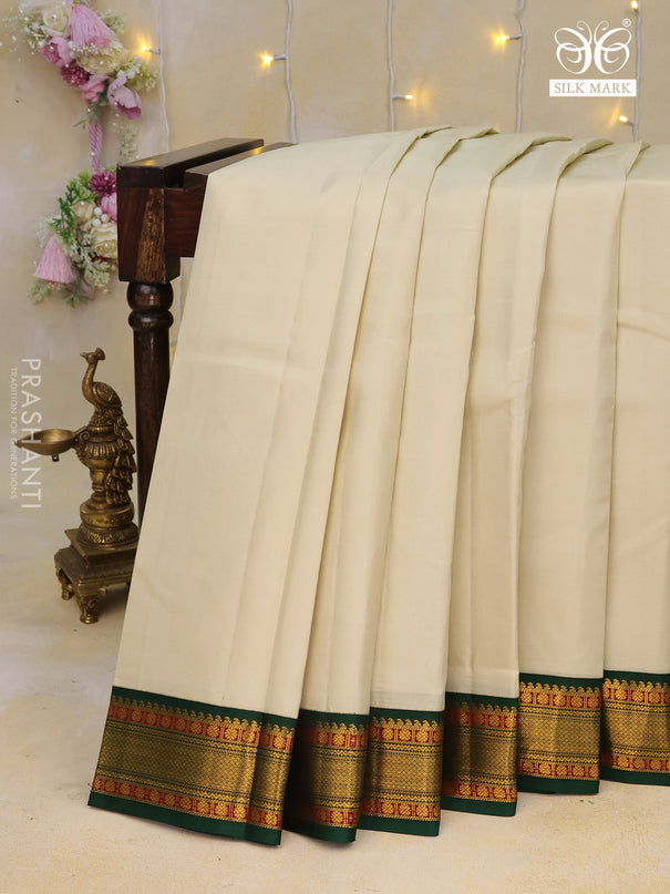 Pure kanchipuram silk saree cream and dark green with plain body and zari woven korvai border