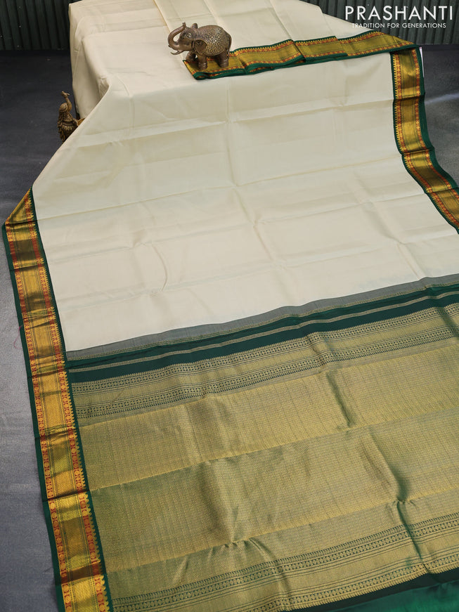 Pure kanchipuram silk saree cream and dark green with plain body and zari woven korvai border