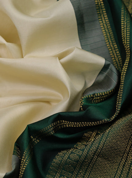 Pure kanchipuram silk saree cream and dark green with plain body and zari woven korvai border