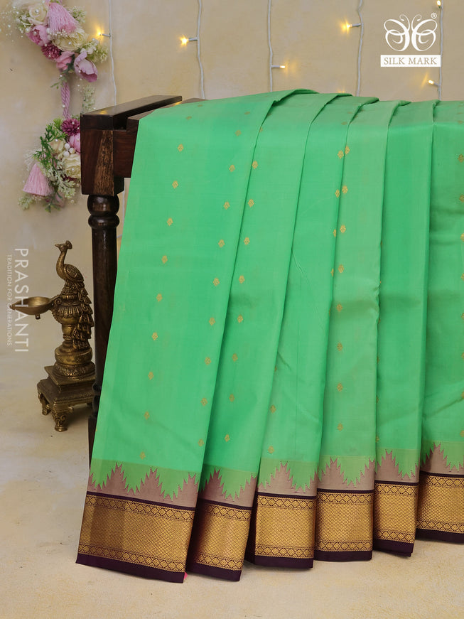 Pure kanchipuram silk saree teal green shade and deep violet with allover zari woven buttas and temple design zari woven border