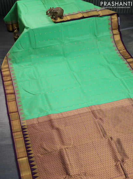 Pure kanchipuram silk saree teal green shade and deep violet with allover zari woven buttas and temple design zari woven border