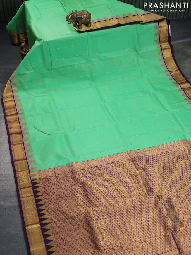 Pure kanchipuram silk saree teal green shade and deep violet with allover zari woven buttas and temple design zari woven border