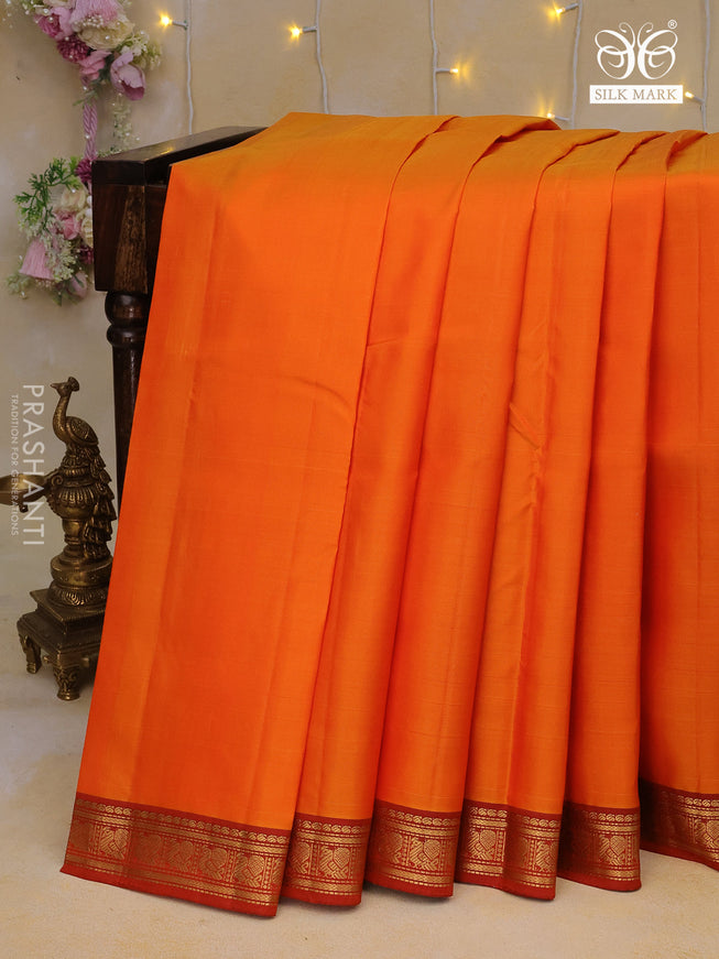 Pure kanchipuram silk saree orange with plain body and zari woven border