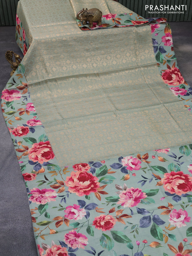 Banarasi silk saree pastel green with allover zari woven brocade weaves and floral digital printed border