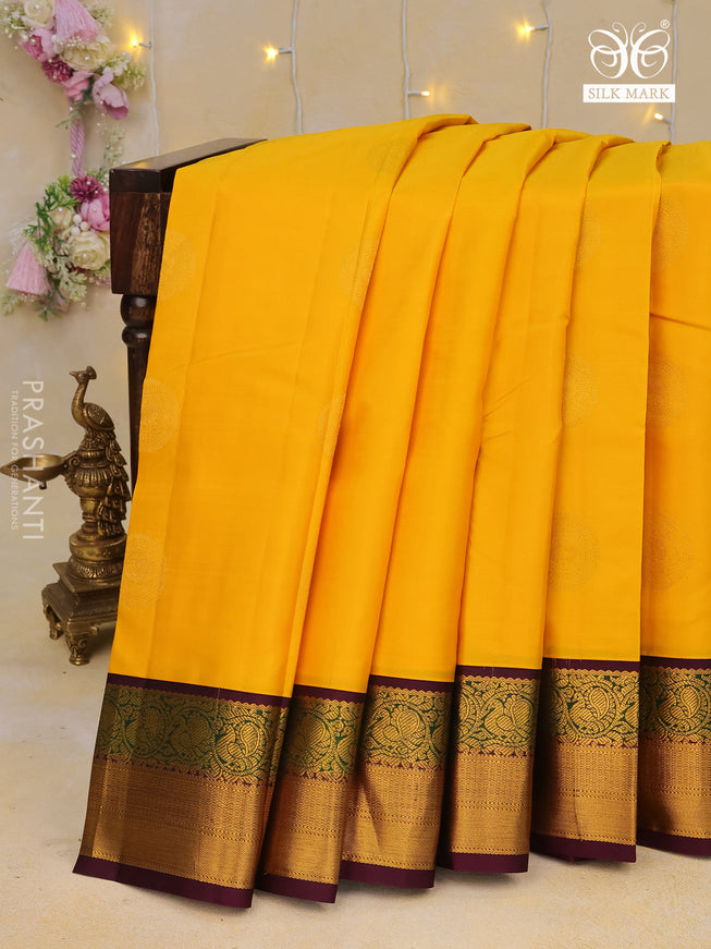 Pure kanchipuram silk saree mango yellow and deep purple with zari woven buttas and annam zari woven korvai border