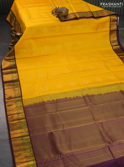 Pure kanchipuram silk saree mango yellow and deep purple with zari woven buttas and annam zari woven korvai border