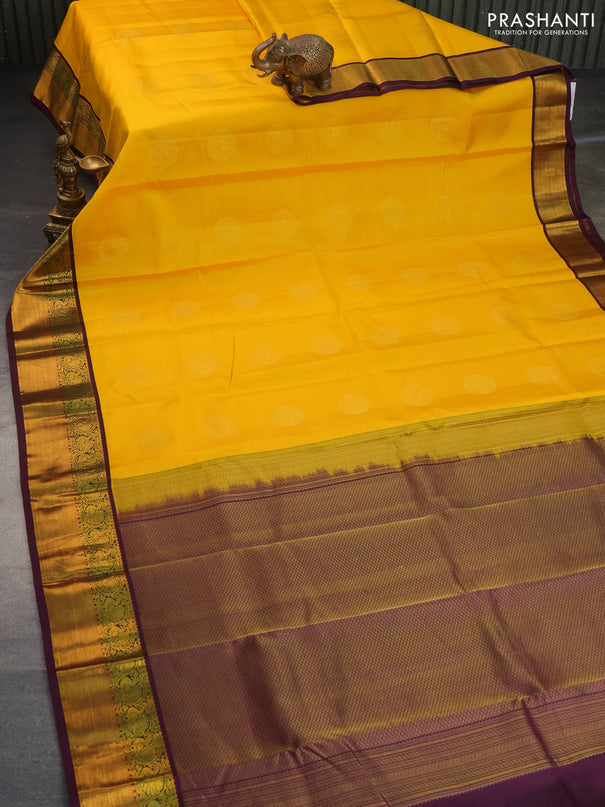 Pure kanchipuram silk saree mango yellow and deep purple with zari woven buttas and annam zari woven korvai border