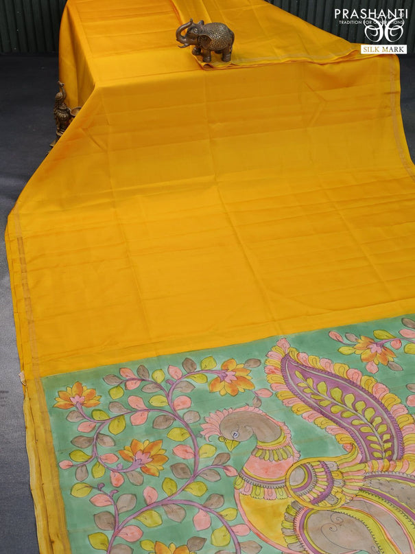 Pure soft silk saree mango yellow and pastel green with plain body and pen kalamkari hand painted pallu