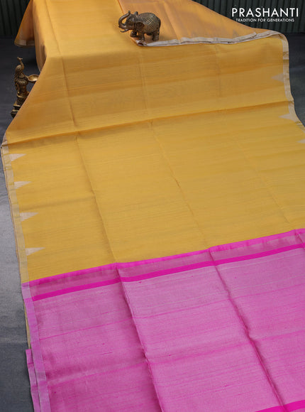 Pure raw silk saree yellow and pink with plain body and temple deisgn silver zari woven border