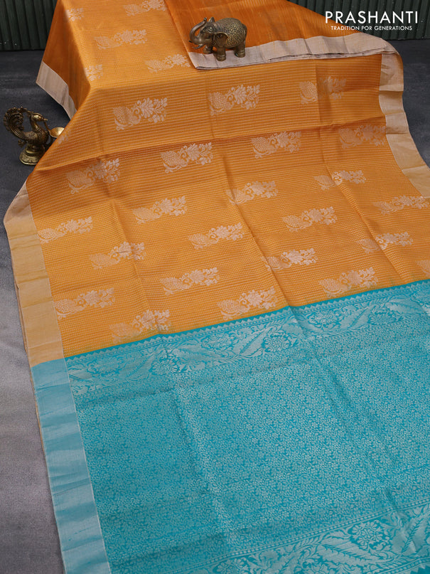 Pure raw silk saree mustard yellow and teal blue with allover silver zari weaves & buttas and silver zari woven border