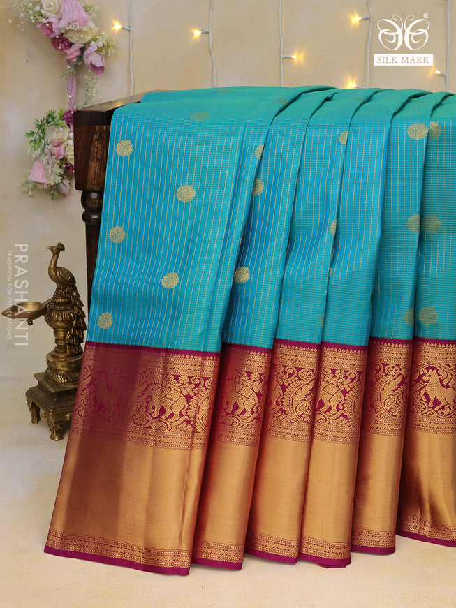 Pure kanchipuram silk saree dual shade of teal blue and purple with allover zari weaves & buttas and long zari woven korvai border