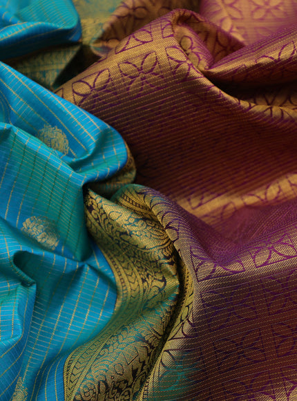 Pure kanchipuram silk saree dual shade of teal blue and purple with allover zari weaves & buttas and long zari woven korvai border