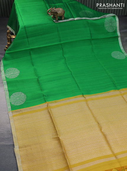 Pure raw silk saree green and mustard yellow with plain body and silver zari woven border