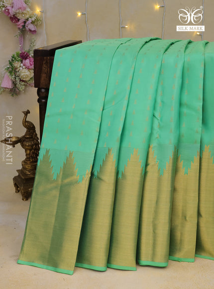 Pure kanchipuram silk saree teal green shade with allover zari woven 1000 buttas and temple design long zari woven border