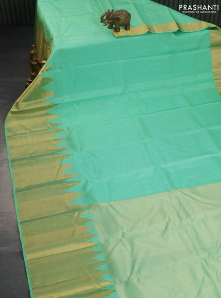 Pure kanchipuram silk saree teal green shade with allover zari woven 1000 buttas and temple design long zari woven border