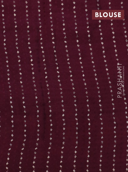 Pure georgette saree maroon with allover zari checked pattern and floral deisgn embroidery work border