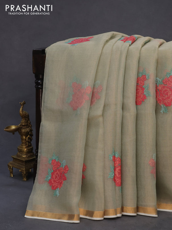 Pure organza tissue silk saree pastel green shade with floral embroidery work buttas and zari woven border