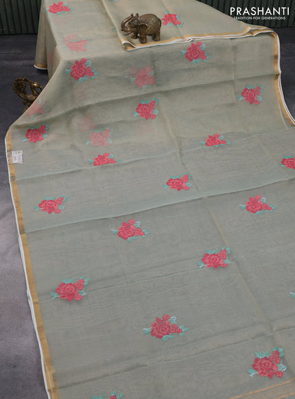 Pure organza tissue silk saree pastel green shade with floral embroidery work buttas and zari woven border