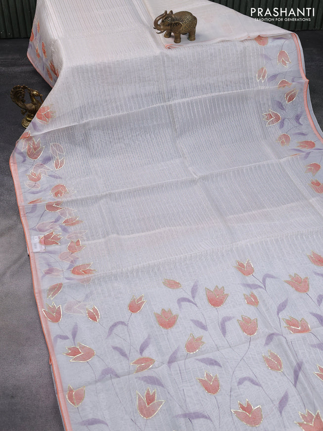 Pure organza silk saree off white and peach orange with allover zari stripe pattern and floral digital prints beaded work border