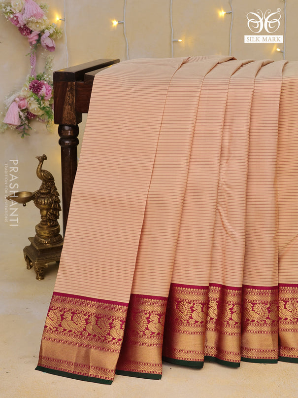 Pure kanchipuram silk saree sandal and magenta pink with allover strips pattern and annam zari woven korvai border