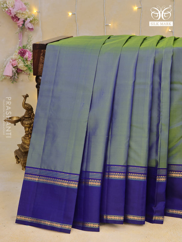 Pure kanchipuram silk saree dual shade of bluish green and blue with plain body and rettapet long zari woven border