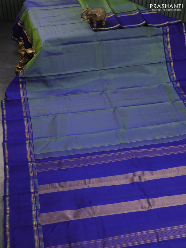 Pure kanchipuram silk saree dual shade of bluish green and blue with plain body and rettapet long zari woven border