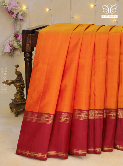 Pure kanchipuram silk saree orange and maroon with plain body and rettapet long zari woven border