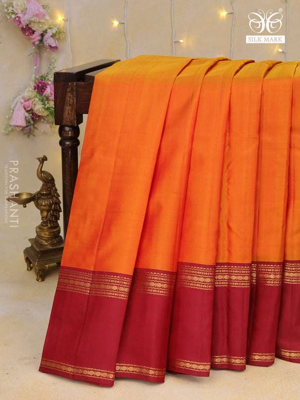 Pure kanchipuram silk saree orange and maroon with plain body and rettapet long zari woven border