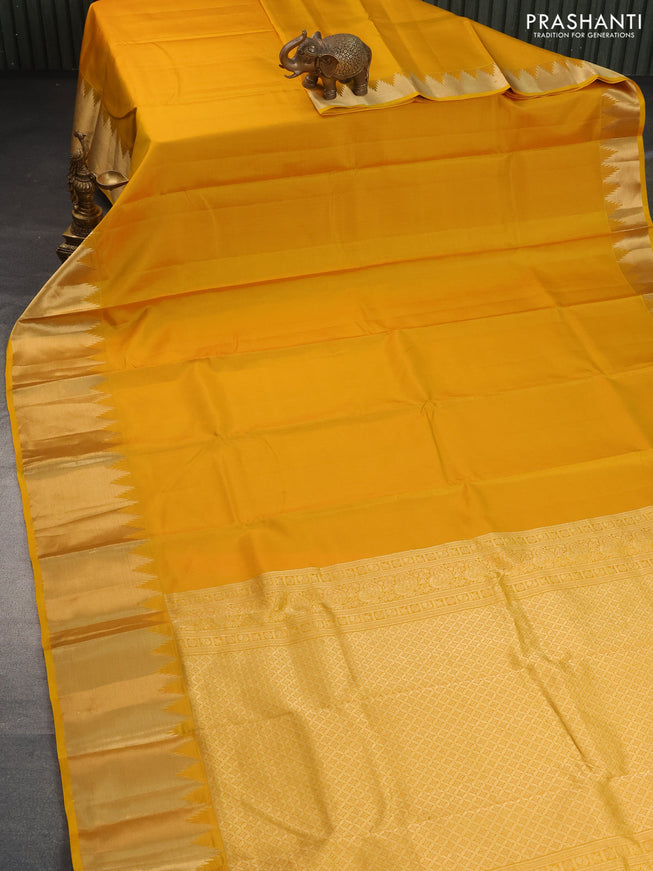 Pure kanchipuram silk saree mustard yellow with plain body and temple design zari woven border