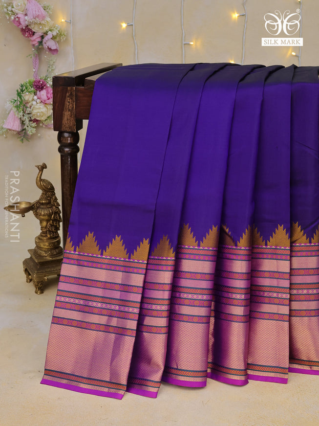 Pure kanchipuram silk saree navy blue and purple with plain body and temple design long zari woven border