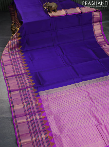 Pure kanchipuram silk saree navy blue and purple with plain body and temple design long zari woven border