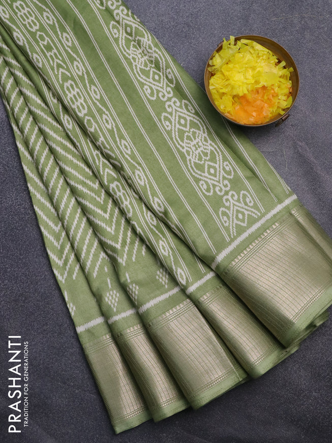 Semi dola saree pastel green with allover zig zag ikat weaves and zari woven border