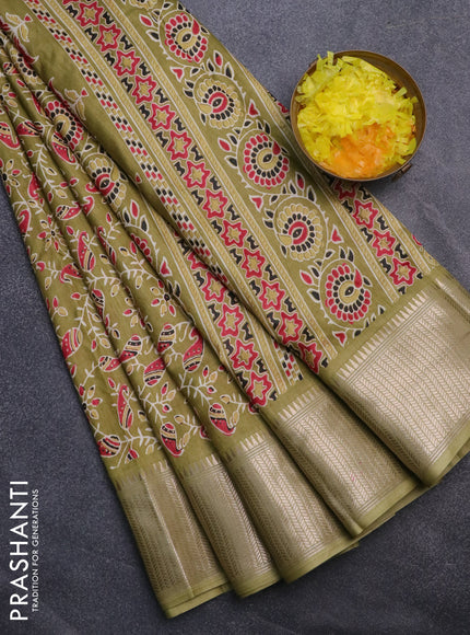 Semi dola saree mehendi green with allover prints and zari woven border