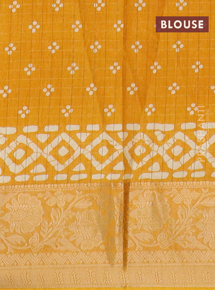 Semi dola saree mango yellow with allover zari checks & batik prints and zari woven border