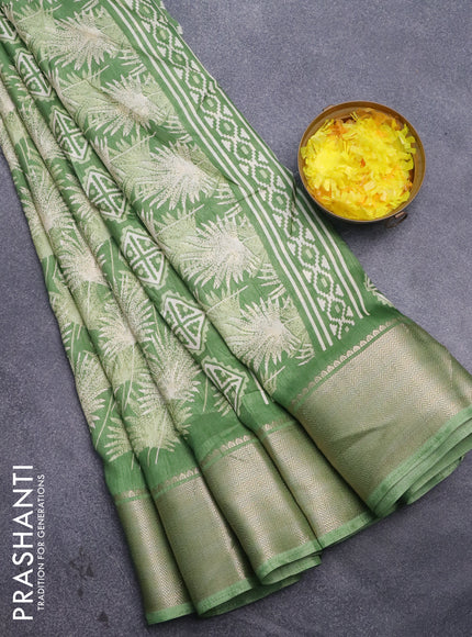 Semi dola saree green shade with allover prints and zari woven border