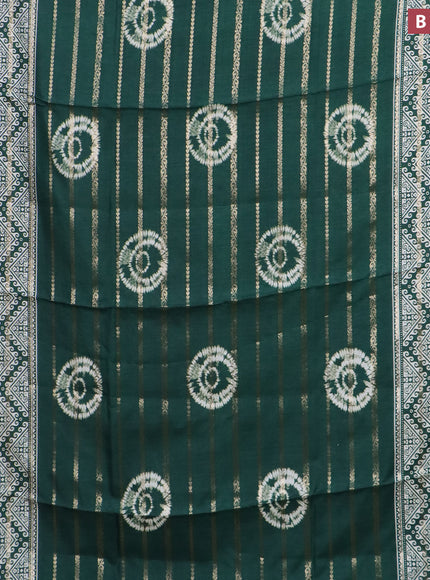 Semi dola saree green with allover zari strips & butta prints and zari woven border