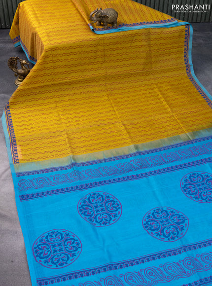 Silk cotton block printed saree mustard shade and blue with allover prints and printed border