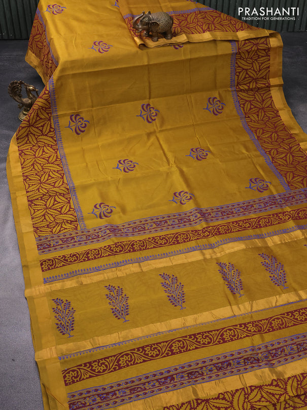 Silk cotton block printed saree dark mustard with butta prints and zari woven border