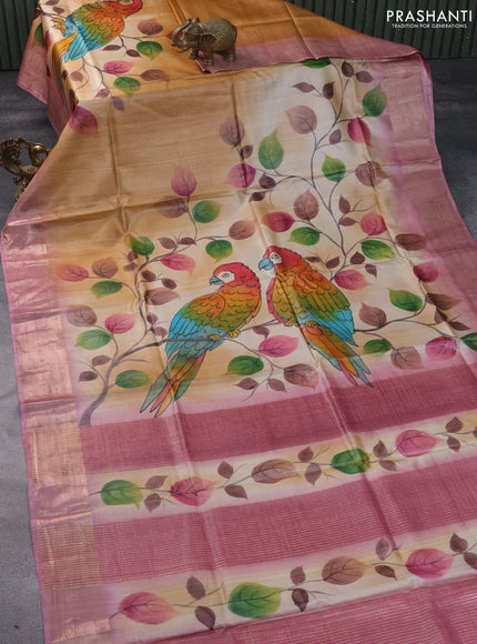 Pure tussar silk saree sandal and pastel pink with hand painted floral prints and zari woven border