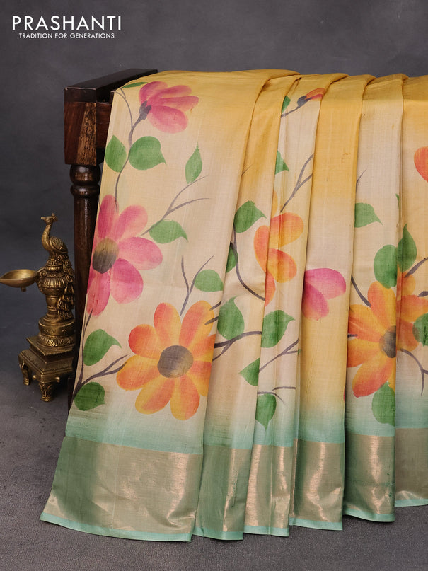 Pure tussar silk saree cream and pastel blue with hand painted floral prints and zari woven border