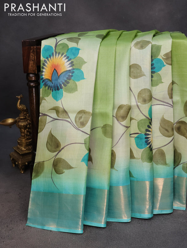 Pure tussar silk saree pastel green and teal blue with hand painted floral prints and zari woven border