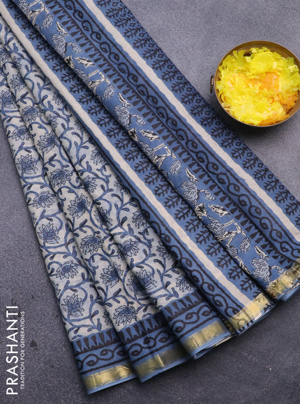 Muslin cotton saree cream and blue with allover floral prints and small zari woven border