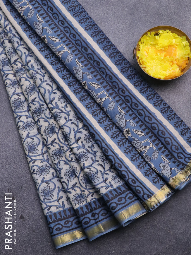 Muslin cotton saree cream and blue with allover floral prints and small zari woven border