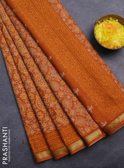 Muslin cotton saree dark mustard with allover ajrakh prints and small zari woven border