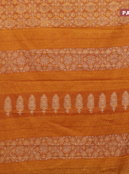 Muslin cotton saree dark mustard with allover ajrakh prints and small zari woven border